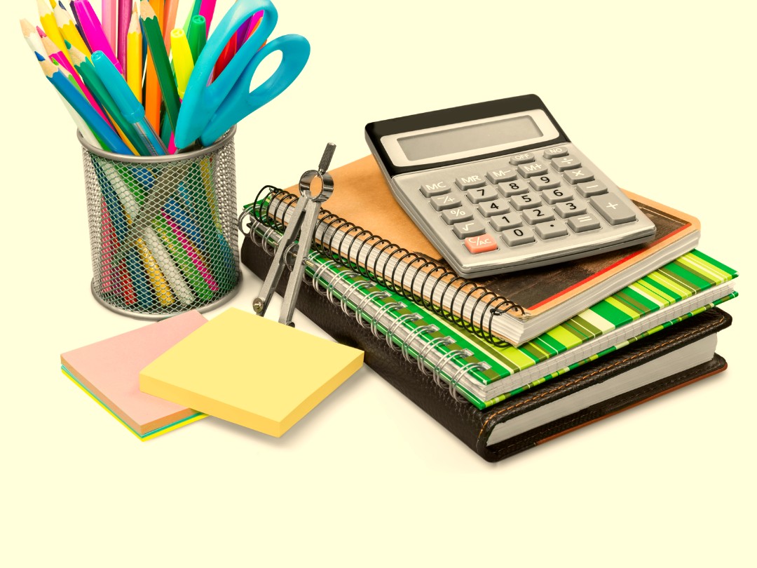 Colored pencils, scissors, notebooks, and calculator for school supplies